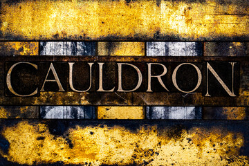 Cauldron text in real authentic typeset letters on vintage textured silver grunge copper and gold background