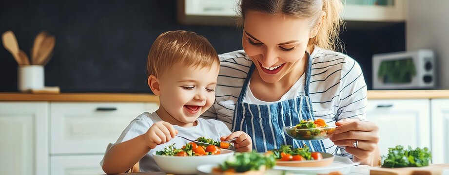 A joyful moment shared between a mother and her child while enjoying a healthy meal together in a modern kitchen.