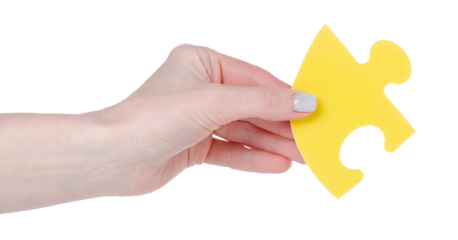 Yellow puzzle in hand isolation