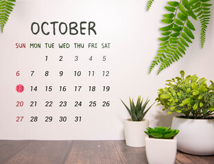 White block calendar present date 13 and month October on wood background.