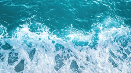 Fototapeta premium Ocean sea surface with pure turquoise water, foamy crests, and gentle waves
