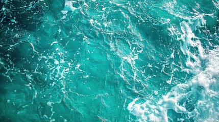 Fototapeta premium Clear blue turquoise water with frothy waves and intricate water textures