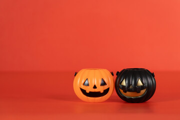 Halloween and decoration concept. Pumpkins orange and black on table with orange background. Jack o lantern pumpkin decoration