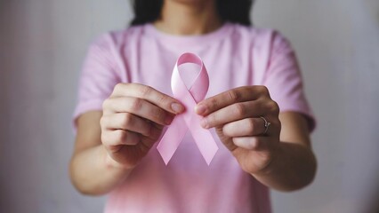 Woman hold pink ribbon breast cancer awareness. Female health check consciousness. international Women Day and World Cancer Day. sign cancer, Symbolic, health care, support patients, timely diagnosis
