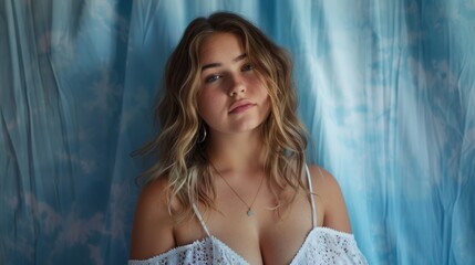 Naklejka premium portrait of beautiful woman with blue curtain type background