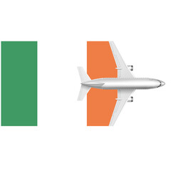 Irish Travel:  A white airplane with orange and green wings flies over a white background with a green and orange flag in the background.  