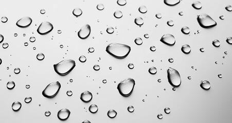 Stock image of raindrops falling on a flat surface isolated on a white background