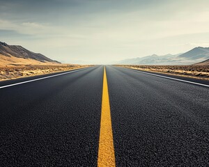 Fototapeta premium A smooth desert highway stretching across the horizon, framed by rocky mountains and a bright sky desert highway, asphalt, smooth surface
