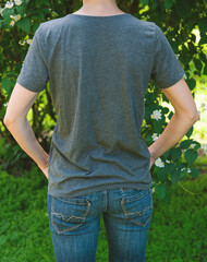 Woman wears grey t-shirt back view mockup ideal for branding and design