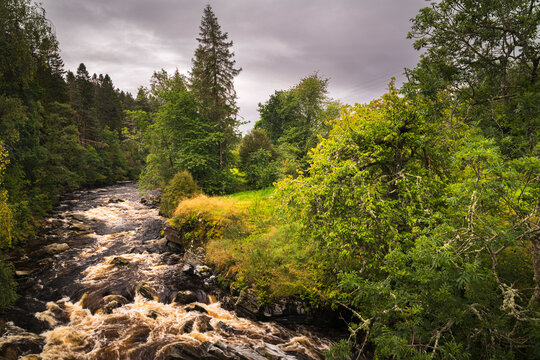 A dull, summer HDR image of the River Feshie and some autumnal colour taken from the bridge at Feshiebridge, Badenoch, Scotland