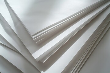 Obraz premium A stack of white sheets of paper on a table, great for office or school scenes