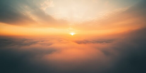 Fototapeta premium A breathtaking sunrise over the clouds, showcasing vibrant colors and a serene atmosphere, perfect for nature lovers and dreamers.