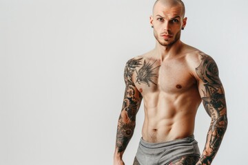 A person with colorful tattoos on their arms and chest