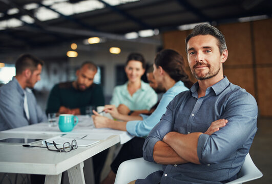 Portrait, arms crossed and business man at meeting for coworking, pride or leadership experience. Face, professional or confident project manager working with creative team planning at startup office