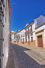 Outdoor, houses and street with traditional architecture in neighborhood of Spain. Outside, alley and road in village with cultural or vintage design as holiday or vacation destination for tourism