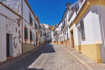 Outdoor, houses and street in neighborhood with traditional architecture in Spain. Outside, home and road in village with cultural or vintage design as holiday or vacation destination for tourism