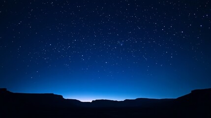 Obraz premium Deep blue sky during twilight, stars visible,