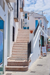 Steps, town and outdoor architecture on vacation, Europe summer and historical culture on getaway. Stairs, city and traditional buildings in destination, tourism and urban holiday in Frigiliana