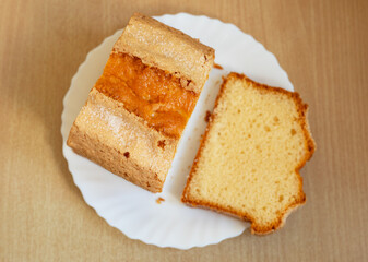 Piece of shortbread cake sprinkled with sugar on white plate.