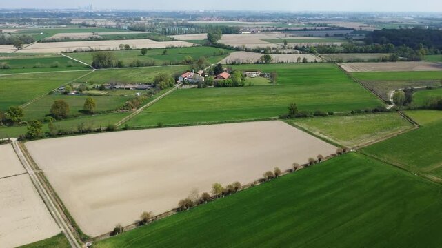 drone shot flying over green fields in the Milanese hinterland