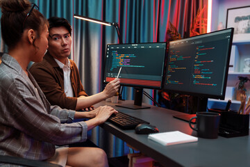 IT developers discussing with point to intelligent website development coder system running data...