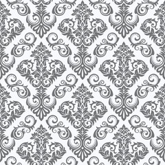 A decorative pattern featuring intricate floral and scroll designs in gray tones on a light background.