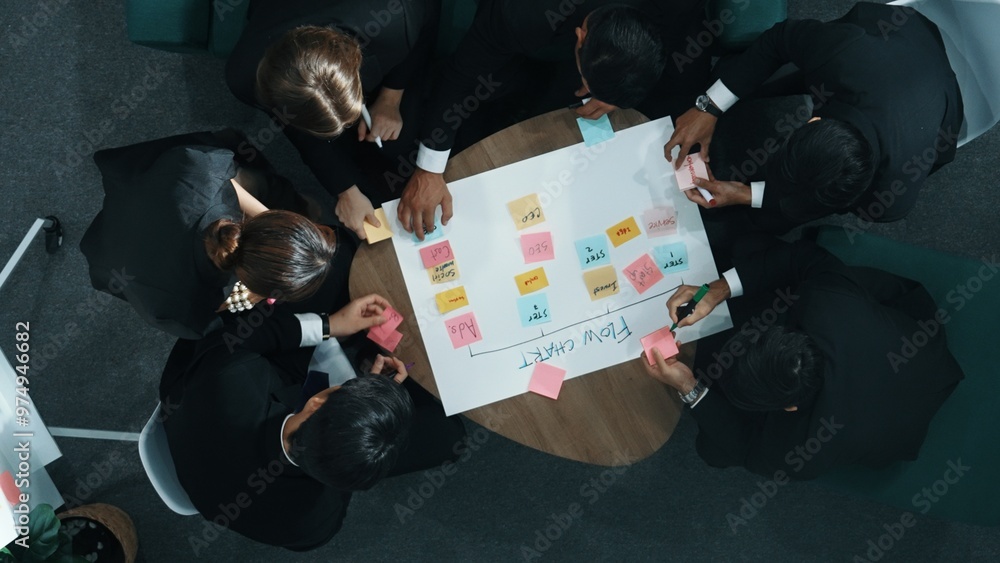 Poster close up of professional business team hands writing and putting sticky note on scrum task board. to