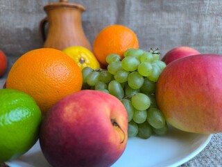 Assorted fruits and vegetables on a white plate. high-quality photo