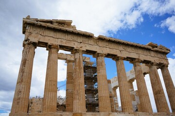 Columns and marble remains of the mighty Parthenon on the hill of the Acropolis in Athens, sacred temples of the goddess Athena and tutelary goddess of the city - sightseeing and vacation in Greece