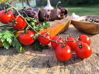 juicy steak on a chopping board surrounded by vegetables and fruits. High quality photo