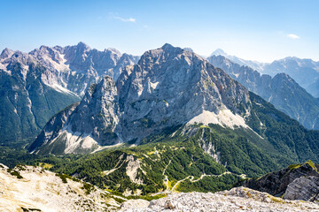 The breathtaking Julian Alps showcase the towering peaks of Skrlatica, Prisank, and Triglav,...