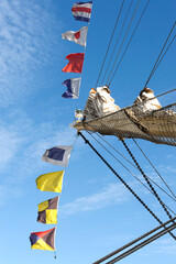 Sailing ship signal flags in the wind.