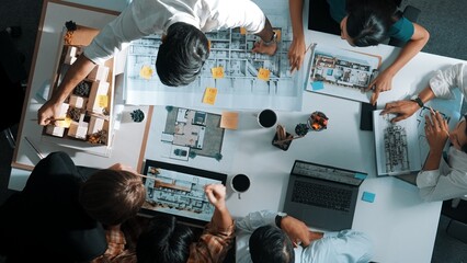 Top aerial view of project manager or civil engineer writing at blueprint and planning building...