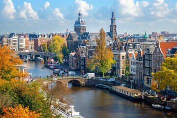 Fototapeta premium Scenic autumn view of the canals in amsterdam with the zuiderkerk and the oude kerk churches in the background