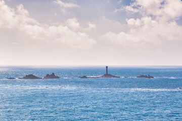 Distant Lighthouse on Rocky Island at Land's End in Cornwall, UK