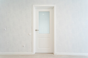 An Elegant Minimalist White Door beautifully complements a Modern Interior Design, enhanced by a Soft Wall Texture that adds depth and warmth