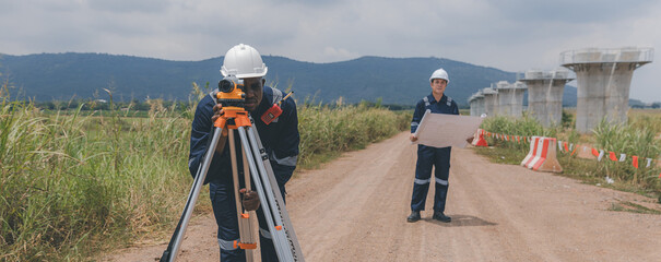 Surveyor engineer worker making measuring with theodolite tool equipment at construction site....
