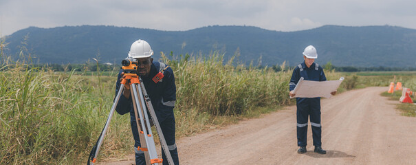 Surveyor engineer worker making measuring with theodolite tool equipment at construction site....