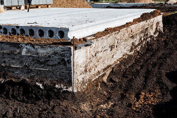 Construction Site Foundation A sturdy concrete base paired with surrounding soil to support the structure effectively and sustainably