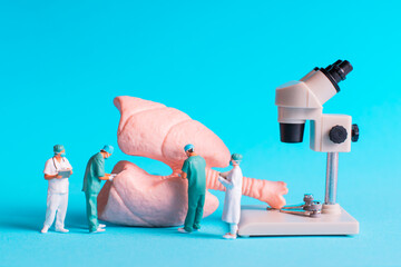 Lungs Examined Under Microscope by Medical Team on Blue Background