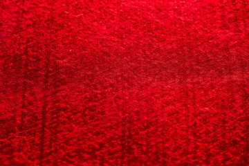close-up of a metallic red shiny and scratched surface