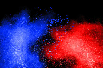 Blue and Red color powder explosion on black background. Colored cloud. Colorful dust explode....