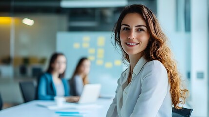 Fototapeta premium Smiling Woman in a White Blouse in a Modern Office Setting