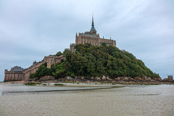 Abbey Mont Saint-Michel (VII century) at rocky tidal island in Normandy - one of most visited...
