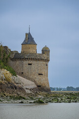 Abbey Mont Saint-Michel (VII century) at rocky tidal island in Normandy - one of most visited tourist sites in France. Low tide. Normandy, Northern France, Europe.