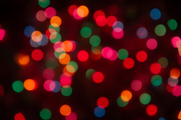 Christmas colorful bokeh lights. Photography taken on a christmas tree. Blurred circle shapes background photography