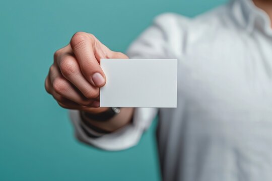 A person holding out their hand for an office business card