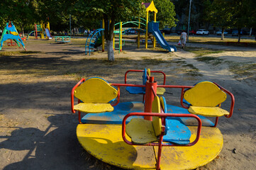 children's swing in the park during the day in autumn urban development public park promotions...