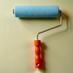 Obraz premium A paint roller with a red handle is on a yellow background