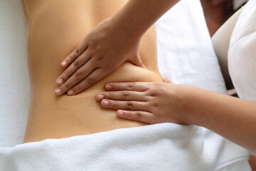 Closeup woman customer enjoying relaxing anti-stress spa massage and pampering with beauty skin recreation leisure in day light ambient salon spa at luxury resort or hotel. Quiescent